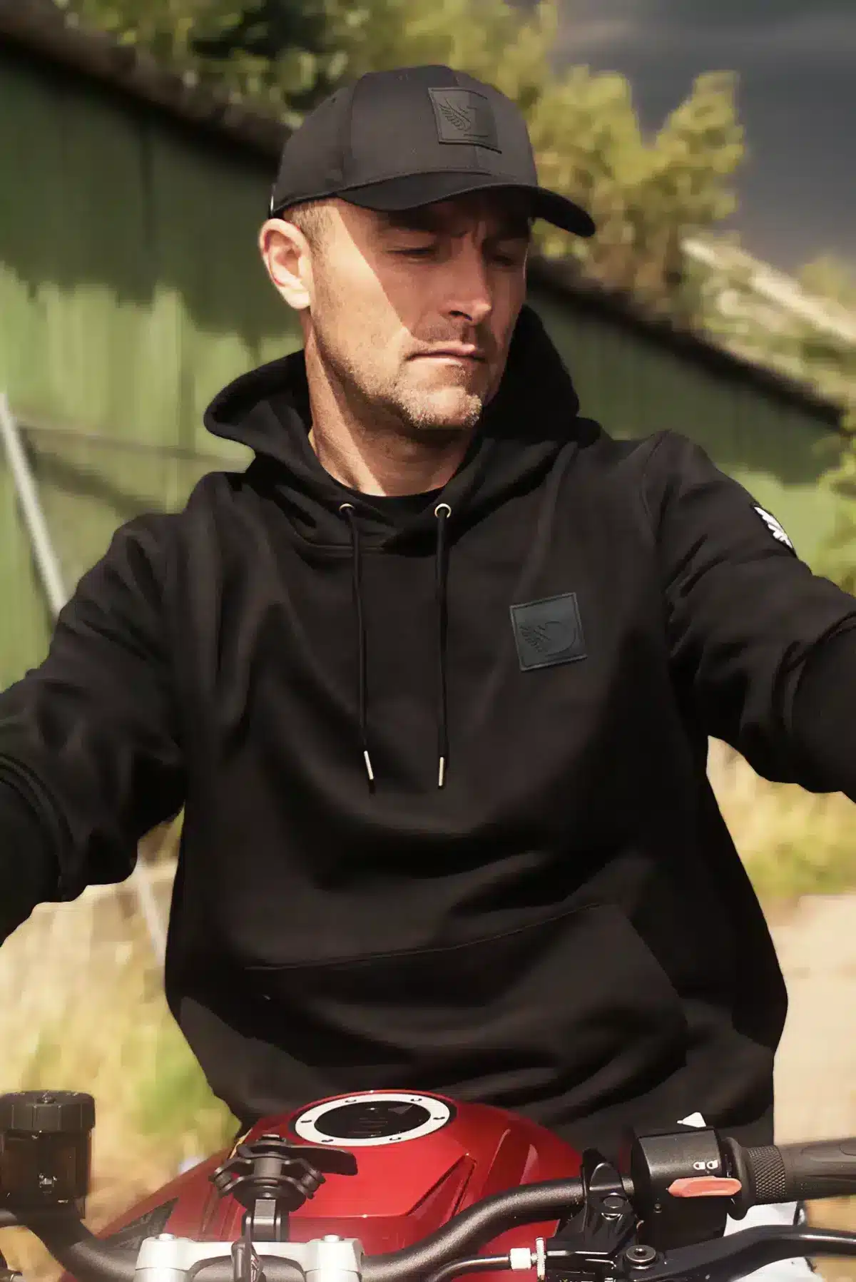 Biker wearing the DROW Wear AJ Stealth Hoodie with British military-inspired design.