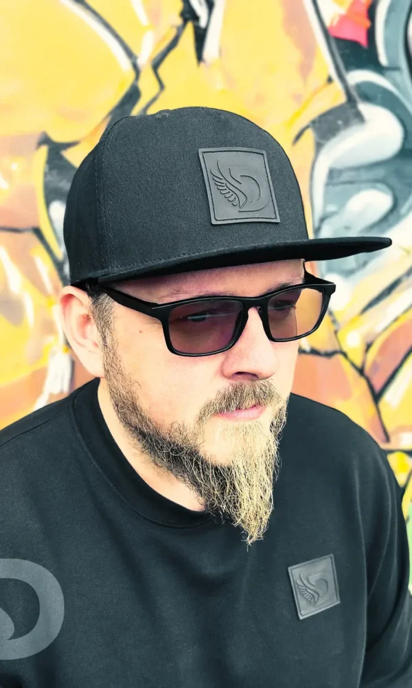 Front view of a man wearing the DROW Snapback featuring the iconic rubber D patch.