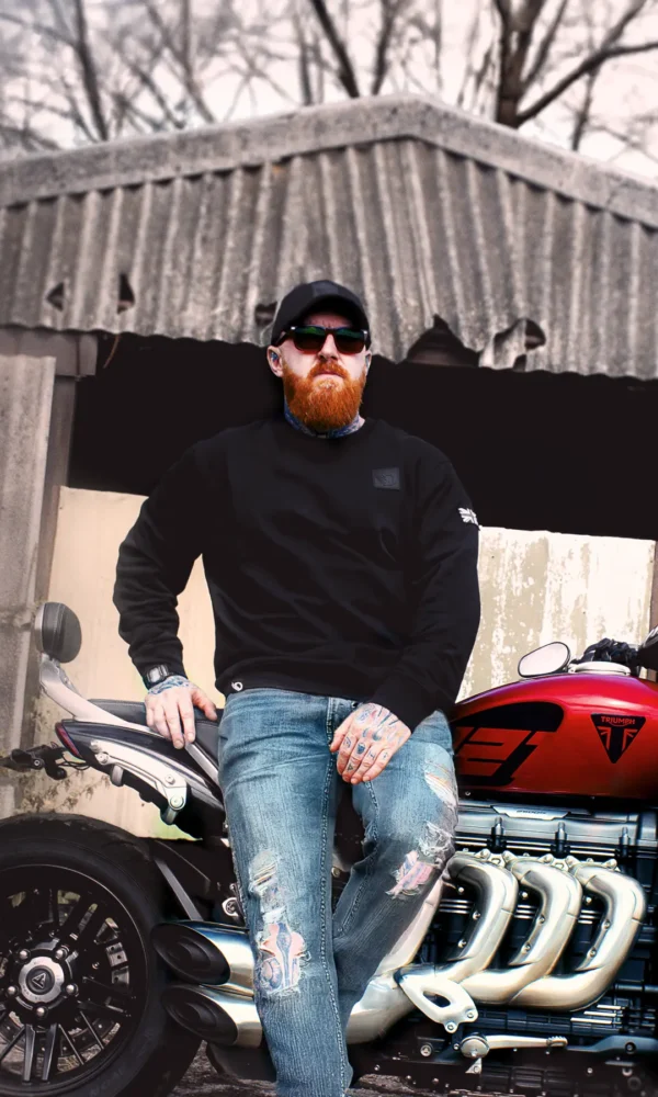 A Man wearing the AJ Stealth Sweatshirt sat on his motorbike