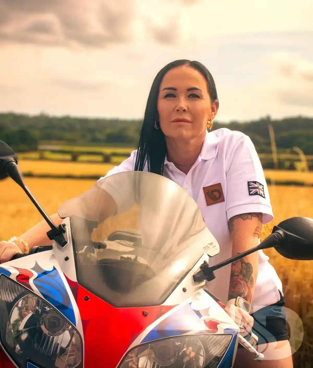 Woman wearing white DROW Wear Heritage Polo with British military-inspired design.