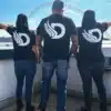 2 Women and 1 Man wearing the DROW Wear Big D T-Shirt Back View